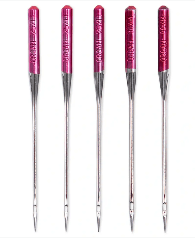 Five steel sewing machine needles with pink tops, labeled "ORGAN 75/11" and "ORGAN 90/14".