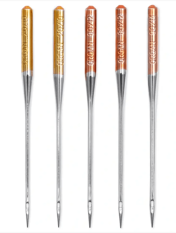 Five assorted jersey sewing machine needles in silver.
