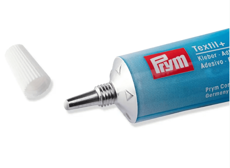 A tube of Prym Textil+ fabric adhesive with the cap off.