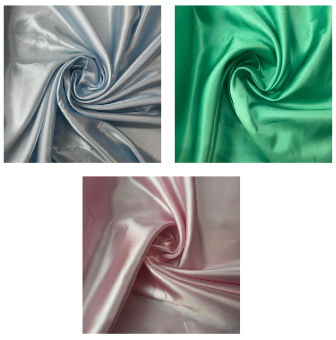 Three swatches of satin fabric in silver, green, and pink.