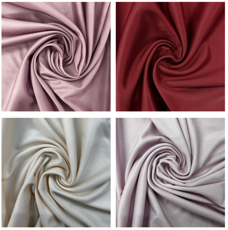 Four square fabric swatches arranged in a 2x2 grid, each showing a different color of the same material swirled into soft folds. The colors are dusty pink, deep burgundy, warm off-white/cream, and pale lavender.