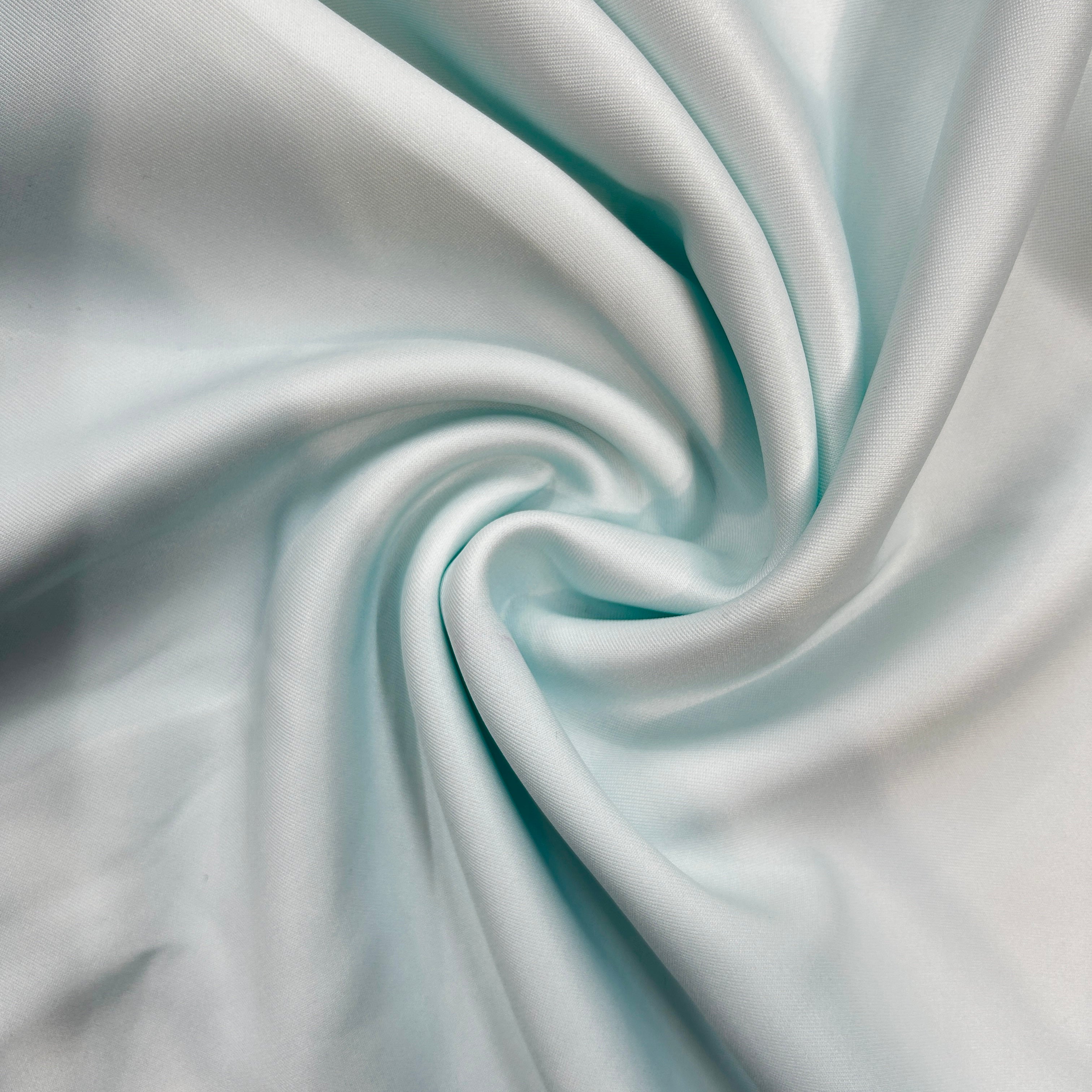 Close-up of light blue fabric with a swirl pattern