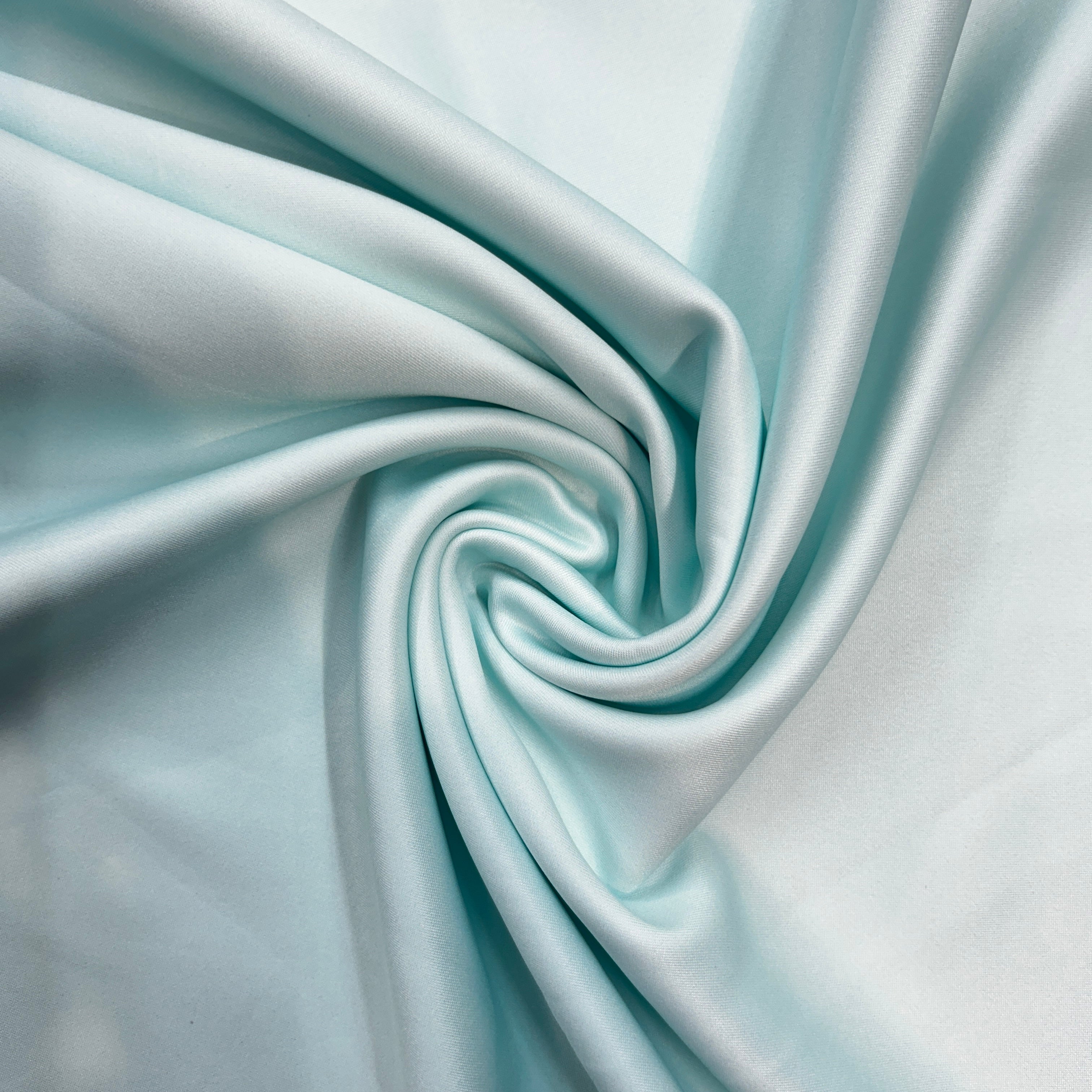 Close-up of light blue fabric with a swirl pattern