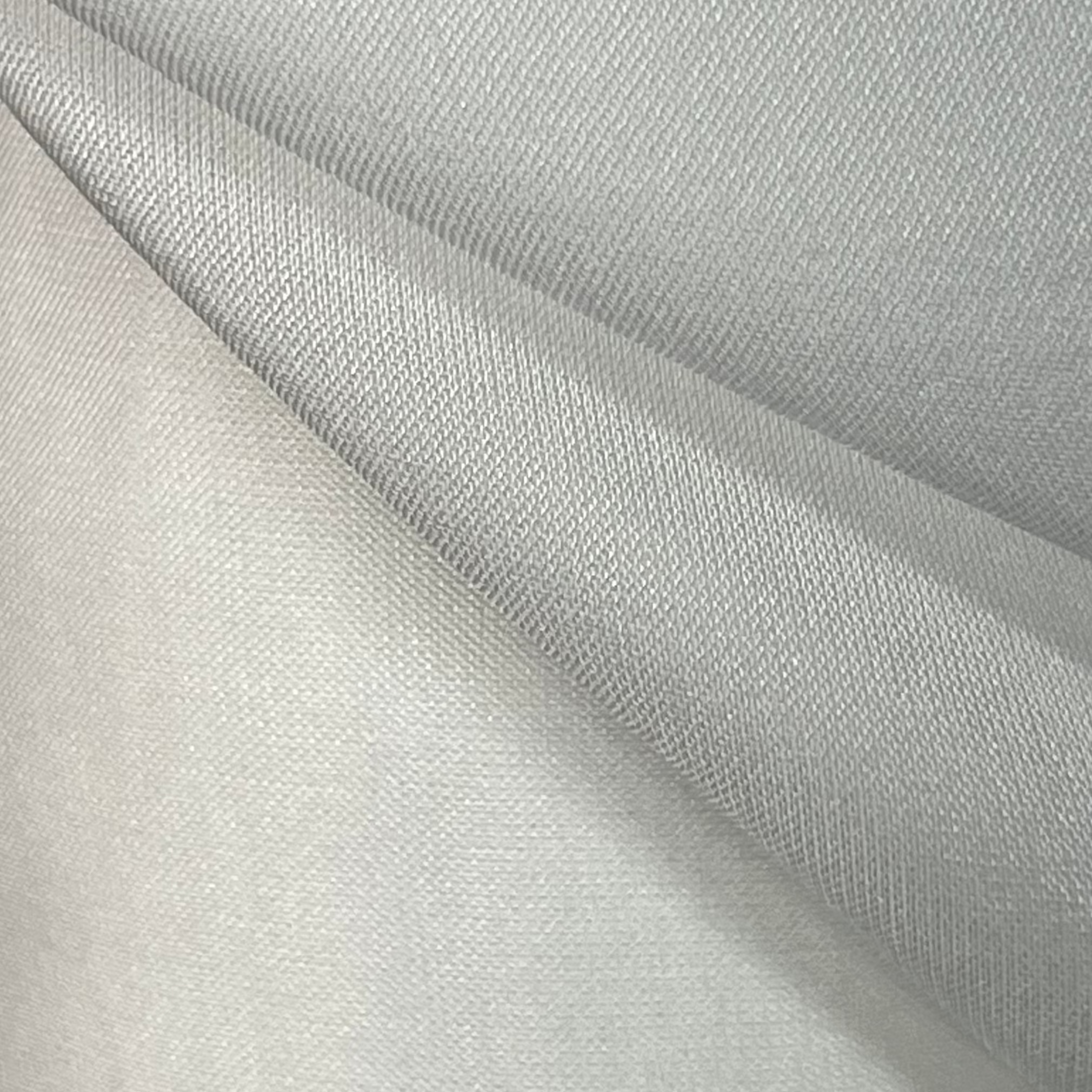 Close-up of light gray fabric with a subtle texture