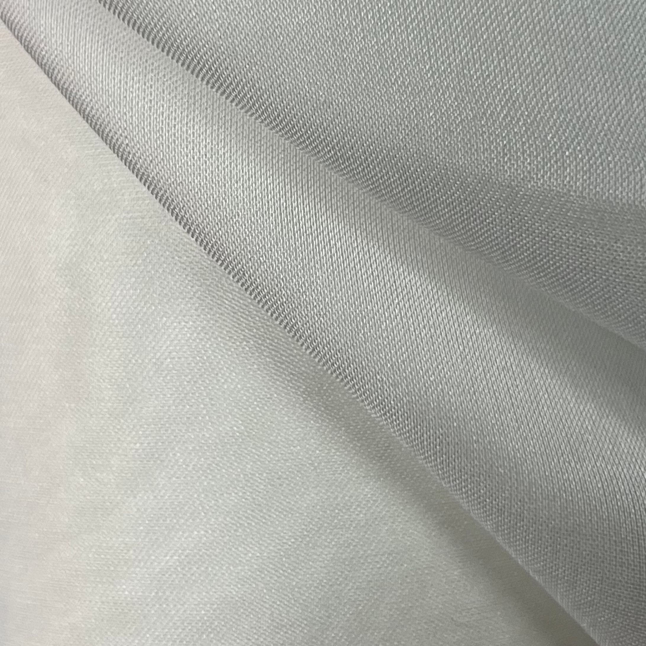 Close-up of light gray fabric with a subtle texture