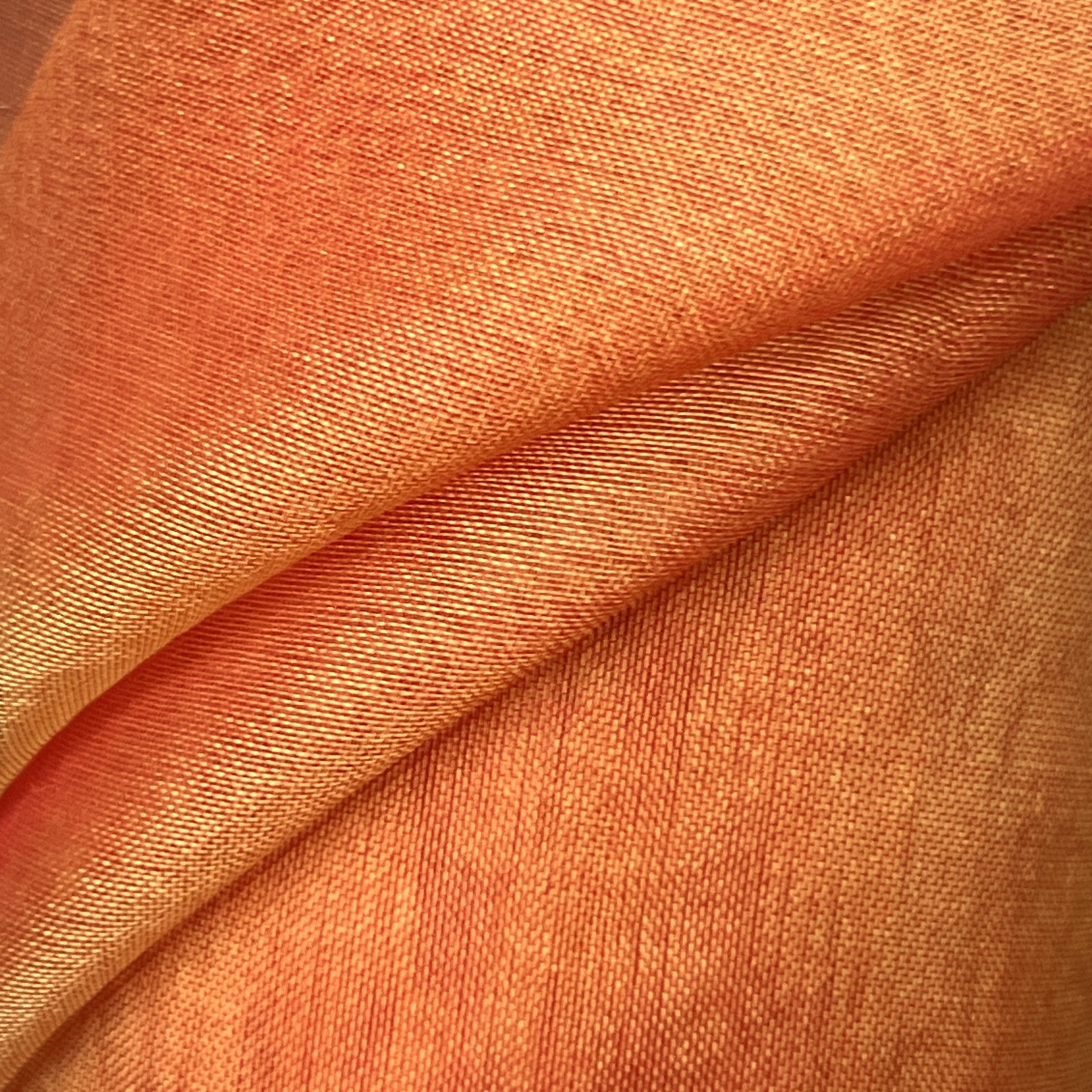 Close-up of orange fabric with visible texture