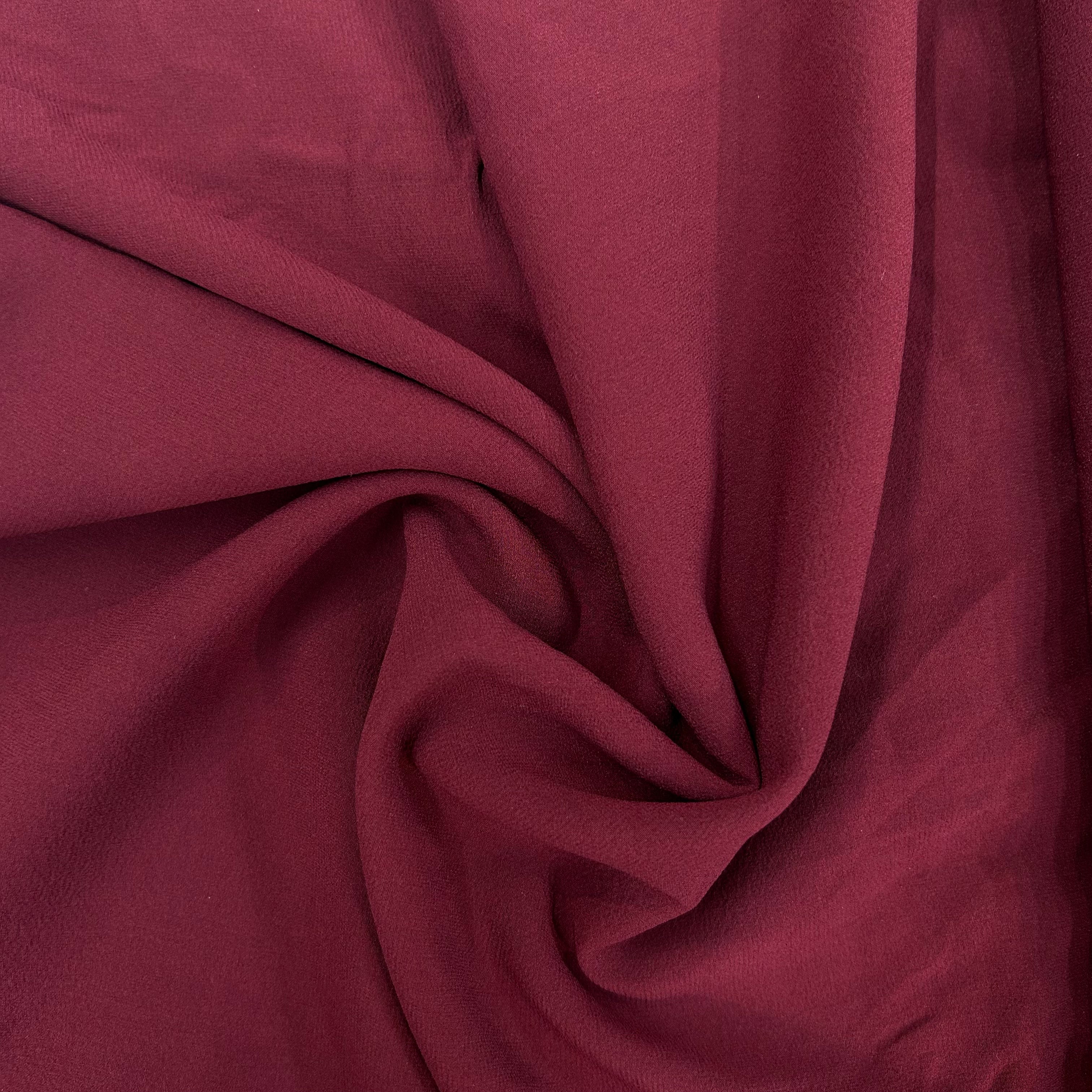 Close-up of maroon fabric with folds