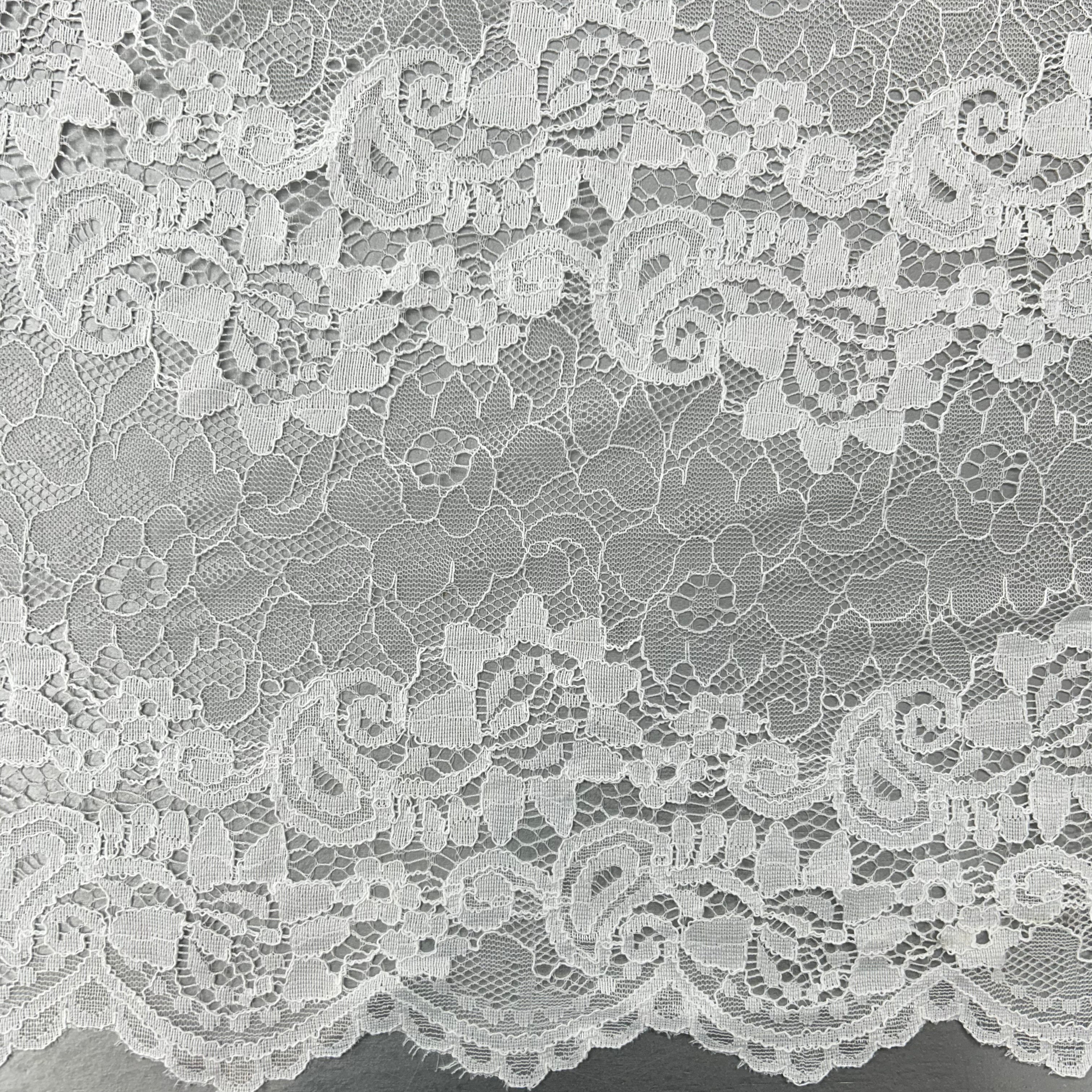 Close-up of white lace fabric with floral patterns