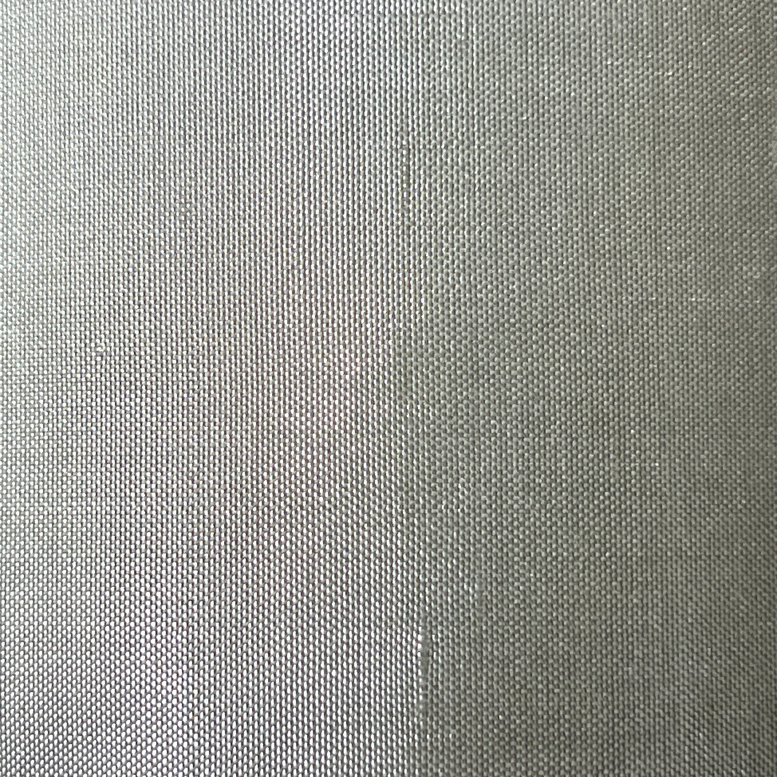 Gradient of gray shades on a textured fabric background