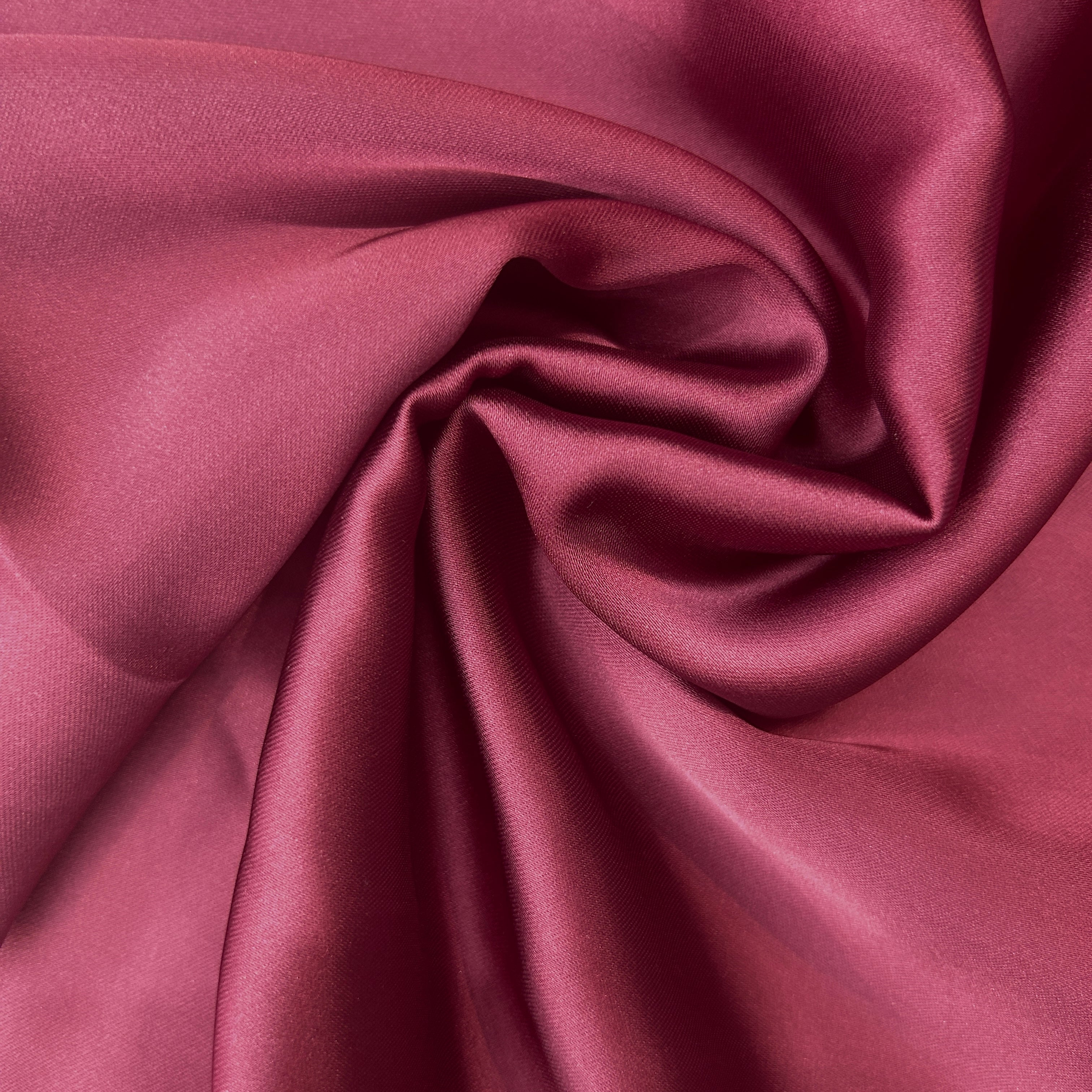 Close-up of maroon fabric with folds