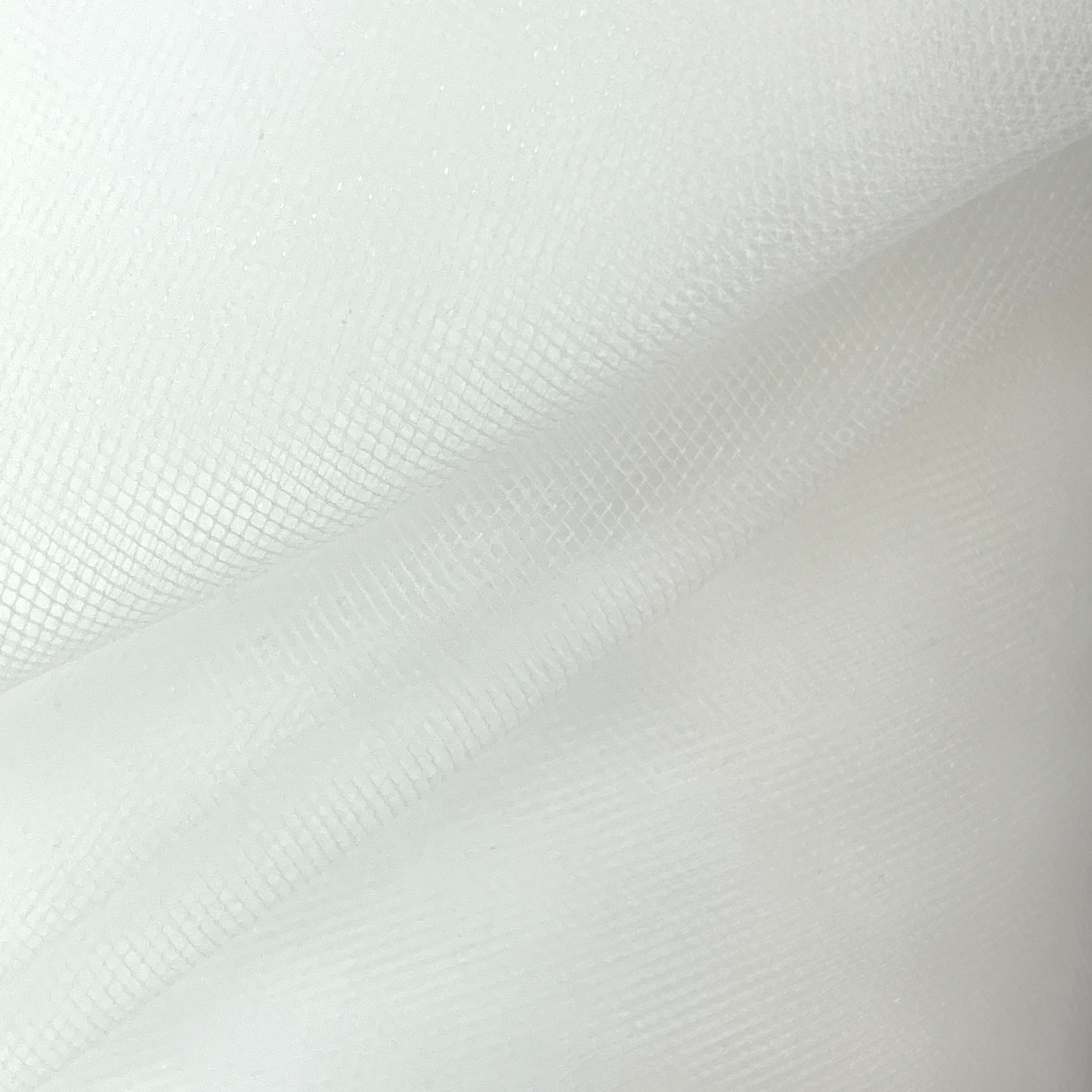 Close-up of white fabric with a subtle pattern